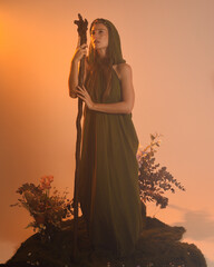 Dramatic portrait of female model figure wearing green fantasy fae cloak costume.
Colourful backlit...