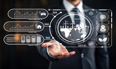 Businessman Presenting Digital Interface with Wind Energy Graphics, Data Analytics, Growth Charts, and Technology Concepts in Modern Office Setting