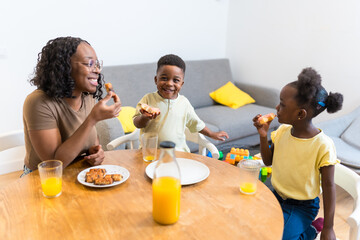 Happy family eating breakfast at home