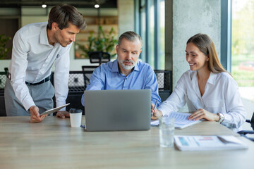 Group of happy progressive business people working on startup together at creative office