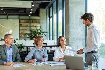Business meeting - manager discussing work with his colleagues.