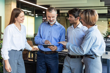 Group of business people standing together and discussing their work and projects, having a team...