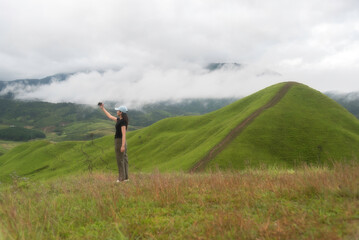 Lifestyle traveler women raise hand feeling good relax and happy freedom   in the sunrise morning....