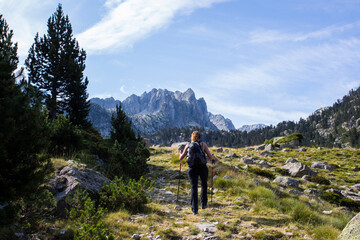 Fototapeta premium Young hiker woman in Vall de Boi, Aiguestortes and Sant Maurici National Park, Spain