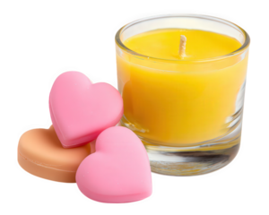 Yellow candle in glass with heart shaped wax melts pink and peach color romantic and cozy atmosphere home decor relaxation love gift soft lighting cheerful mood