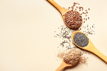 Flaxseeds, chia seeds and bran ground on spoons