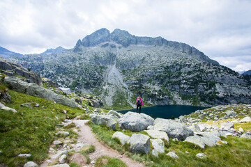 Naklejka premium Young hiker woman in Vall de Boi, Aiguestortes and Sant Maurici National Park, Spain
