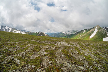 Rocky mountainside, contrast of stones and grass