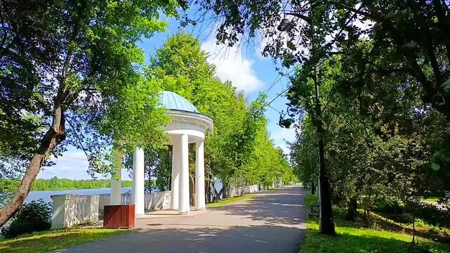 Mendeleevskaya embankment with a rotunda on the bank of Volga river on a sunny windy day in Dubna, Moscow Region, Russia