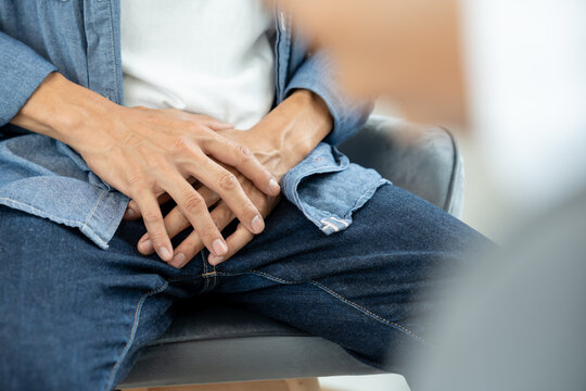 Man hold hand in front of private parts feeling discomfort and consult doctor. Venereal, testicular cancer. bladder problems, erectile dysfunction, premature ejaculation, prostate cancer