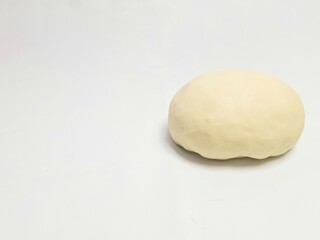 Raw dough ball on a white background, perfect for baking preparation, food blog visuals, or culinary stock images
