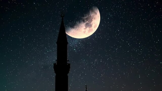 Mosque minaret silhouette under a large illuminated crescent moon against a starry night sky