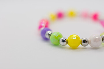 Colorful bracelet with a variety of beads and a silver clasp. The beads are of different colors and...