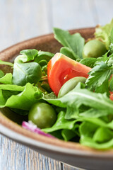 Healthy and tasty salad with tomatoes, olives, cucumber and lettuce.