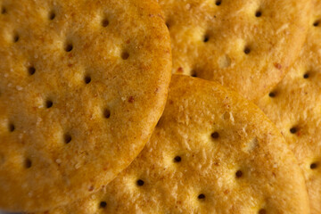 Golden baked crackers stacked together on a surface create an inviting snack display perfect for gatherings or casual enjoyment