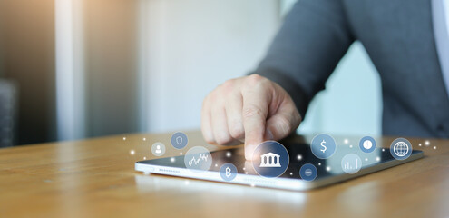 investor businessman hand touch on tablet and access to private banking account application to using system function about checking stock market or transfer money worldwide for future tech concept