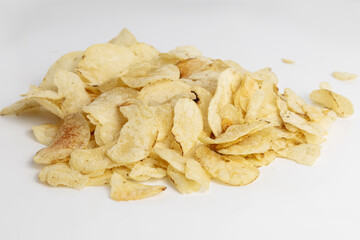 Crispy potato chips piled on a clean surface ready for snacking during a casual gathering or movie...
