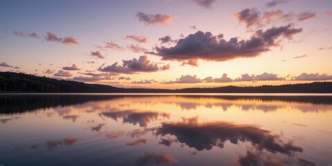  A Reflective Landscape Photograph of a Twilight Sky with Clouds Mirrored in a Calm Lake