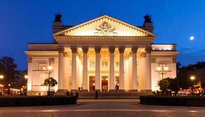 Obraz premium Illuminated Grand Theater Building at Dusk.
