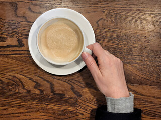 Girl's hand holding a cup of coffee