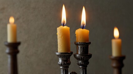 Single lit candle in menorah holder with soft background