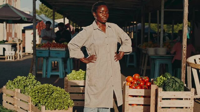 Confident vendor posing with fresh produce at bustling outdoor market stalls