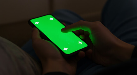 Close-up view of a person's hand in front of a cellphone and ready to click on it, with a green screen on the cellphone screen. Mock up of general information in lifestyle 2