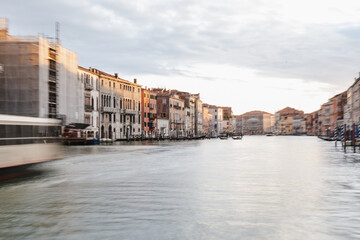Sunset over the tranquil waters of a historic canal in Venice during twilight