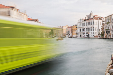 Vibrant waterway of Venice reflecting life and movement during twilight hours