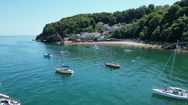 Babbacombe, South Devon, England: DRONE VIEWS: Motorboats and yachts moored in Babbacombe Bay; Babbacombe beach and harbour. Babbacombe is a popular UK holiday destination (Sequence 2 of 3).