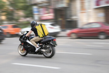 Abstract image of a courier on a motorcycle on a blurred background © Halytskyi Olexandr