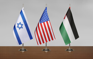 Flags of Israel, USA and Palestine on gray blurred background