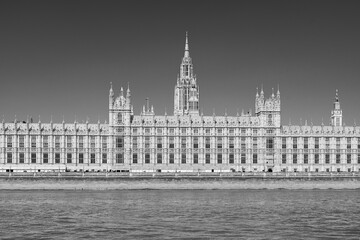 London, England, UK: Waterfront view of the House of Parliament building on the banks of river Thanes in black and white