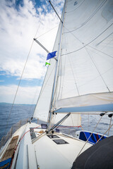 Sailing yacht moving at full speed with all sails up in the open sea near Croatia. Dynamic maritime adventure and freedom of ocean travel.