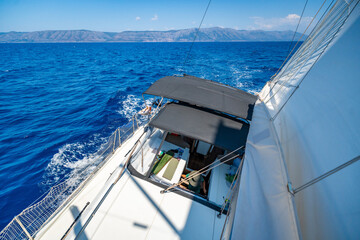View from the mast down to the cockpit of a sailing yacht moving under full sails near Croatia....