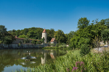 Reflection of the Faulturm in the calm waters of the Rothenburg Pond in Dinkelsbühl, Middle...