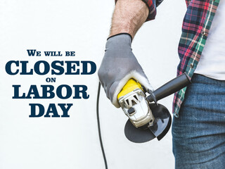 Happy Labor Day. Attractive man and angle grinder. Closeup, studio shot. Congratulations for family, loved ones, friends and colleagues. Concept of preparation for the national holiday
