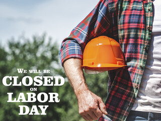 Signboard with the inscription We will be closed on Labor Day. Congratulations for family, loved...