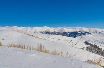 snow covered slopes of Aytsasar mountain from Jermuk ropeway upper station (Vayots Dzor,. Armenia)