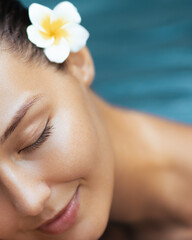 Glowing Woman Relaxing at Spa with Flower in Hair for Beauty Theme