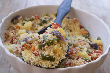 vegetarian couscous salad with roasted vegetables in ceramic bowl