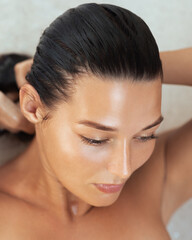 Close-Up of Woman With Wet Hair Tying It Back After Bath for Spa and Haircare