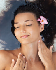 Relaxed Woman in Water With Flower and Wet Hair for Spa and Skincare Concept