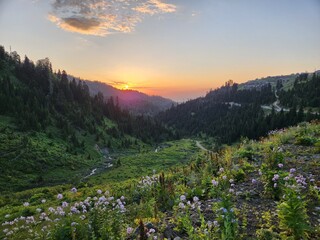 A hike up Gadrekili Hill near Bakhmaro, Georgia, July. Sunset in mountains.