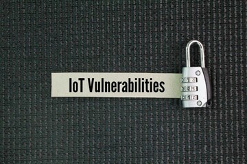 Key and paper with the word IoT Vulnerabilities. security weaknesses in internet-connected devices...