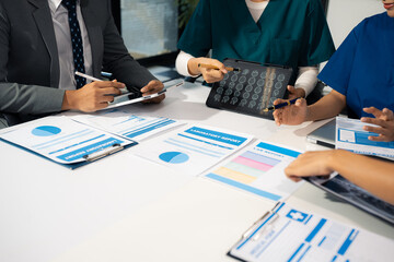 Medical team working on digital tablet healthcare doctor technology tablet using computer analyzed the results of medical reports at the hospital.