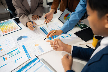 Businessmen team or financial data analysts working with tablets and laptop computers and data...