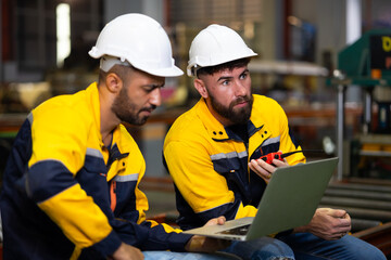 laptop computer : engineer worker working control sheet metal roof machine at metal sheet profiling factory. Industrial production. Service and Maintenance of factory machinery
