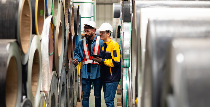 Steel Rolls in Steel Mill. Professional Mechanical Engineer team employees checking production line in wire warehouse. Engineer checking steel rolls. Product quality Inspection - Powered by Adobe