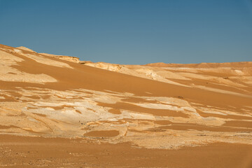 Naklejka premium White rock formations and sand dunes in Egypt's White Desert, natural desert landscape 